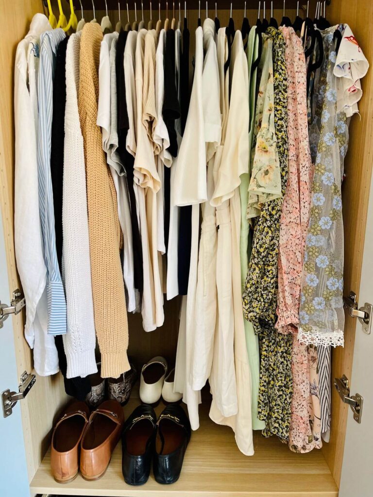 rail with shirts and t-shirts and dresses on black hangers