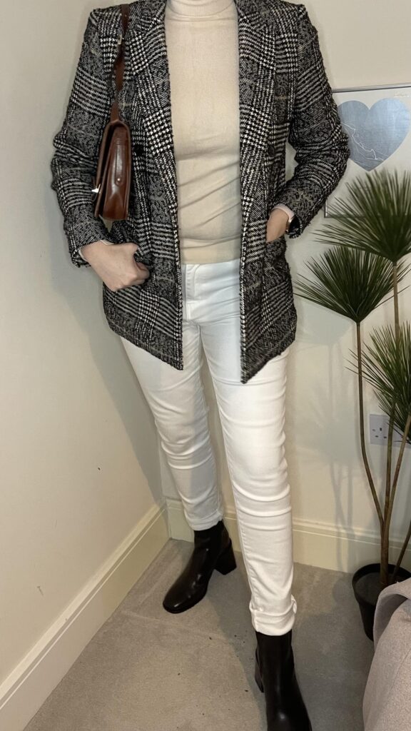 girl posing in black boots and white jeans